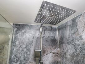 A shower setup with a large shower head and modern faucet at Bay Tree Cottage in Ambleside