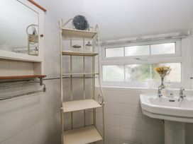A bathroom with shelf and wash basin at Bay Tree Cottage in Ambleside
