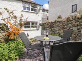 A garden with a table and chairs at Bay Tree Cottage in Ambleside