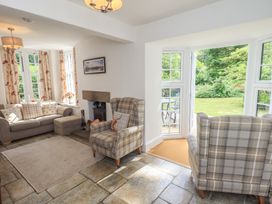 A living room with sofa and armchairs at The Old Post House at Low Stott Park near Newby Bridge