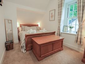 A bedroom with a bed and a window at The Old Post House at Low Stott Park near Newby Bridge