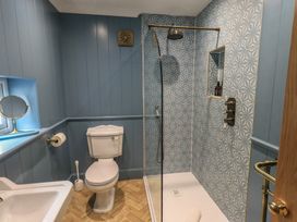 A bathroom with a shower and sink at The Old Post House at Low Stott Park near Newby Bridge