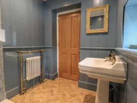 A bathroom featuring a sink and a radiator at The Old Post House at Low Stott Park near Newby Bridge