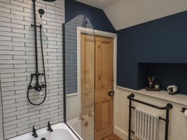 A bathroom with a bathtub and shower at The Old Post House at Low Stott Park near Newby Bridge