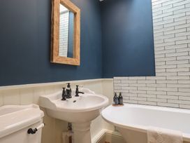 A bathroom with a sink, toilet, and bathtub at The Old Post House at Low Stott Park near Newby Bridge