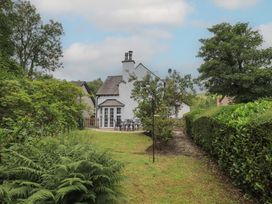 A house with a garden and seating area at The Old Post House at Low Stott Park near Newby Bridge