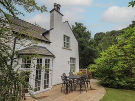 An outdoor area with a table and chairs at The Old Post House at Low Stott Park near Newby Bridge