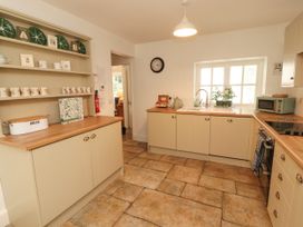 A kitchen with cabinets and a sink at The Old Post House at Low Stott Park near Newby Bridge