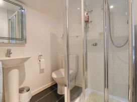 A bathroom with a pedestal sink toilet and glass shower enclosure at The Cottage in Halkyn near Holywell