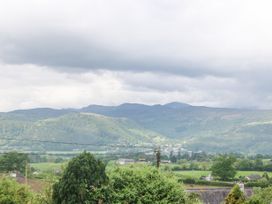 Mountain landscape with green hills trees houses and power lines at Y Stabal in Llanddoged near Llanrwst