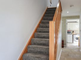 A staircase leading to the upper floor at 15 Boscaswell Downs Pendeen