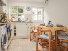 A kitchen with a table and chairs at 15 Boscaswell Downs Pendeen