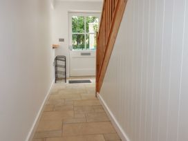 A hallway featuring a staircase and a door at 15 Boscaswell Downs Pendeen