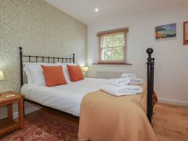 A bedroom with a bed and towels at 15 Boscaswell Downs Pendeen