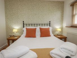 A bedroom with a bed and lamps at 15 Boscaswell Downs in Pendeen