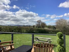 An outdoor seating area with a view of mountains at Cherry Pod Hookagate near Meole Brace