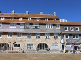 A building with multiple windows and an entrance at The Bay House