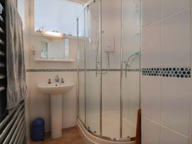 A bathroom with a shower and sink at Flat F