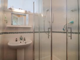 A bathroom with a shower and sink at Flat F