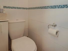A bathroom with a toilet and a sink at Flat F