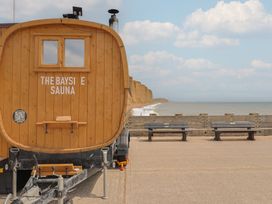 A sauna on a beachfront with benches and cliffs at The Bayside Sauna in 