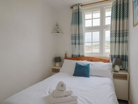 A bedroom with a bed and bedside table at Flat F Bay House in West Bay