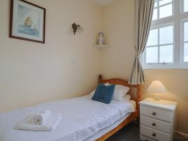 A bedroom featuring a single bed and a nightstand at Flat F Bay House in West Bay