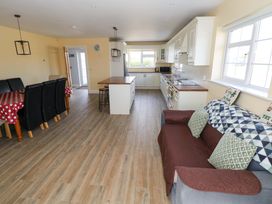 A kitchen with a dining area and seating at Tí Tom Nárta Trabane near Lettermore, County Galway