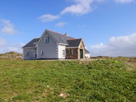 A house with a pitched roof and windows in an outdoor area at Tí Tom Nárta Trabane near Lettermore, County Galway