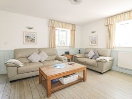 A living room with sofas and a coffee table at Owls Roost in Gorran Haven