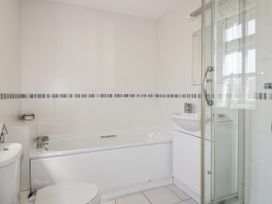 A bathroom with a bath, toilet, sink, and shower at Owls Roost in Gorran Haven