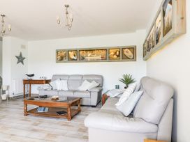 A living room with sofas and a coffee table at Squirrels Dray in Gorran Haven