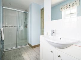 A bathroom with a shower and sink at Squirrels Dray in Gorran Haven