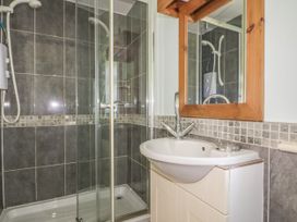 A bathroom with a shower and sink at Foxes Den in Gorran Haven