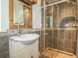 A bathroom with a sink and a shower at Foxes Den in Gorran Haven