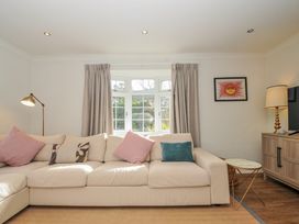 A living room with a sofa and lamp at Samphire in Rock