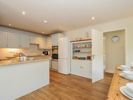 A kitchen with cabinets and countertops at Samphire in Rock