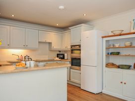 A kitchen with a sink and refrigerator at Samphire in Rock