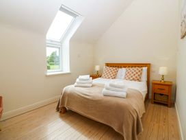 A bedroom with a bed and bedside tables at No 2 The Stables Capel Coch near Llannerch-Y-Medd