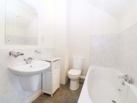 A bathroom featuring a sink, toilet, and bathtub at No 2 The Stables Capel Coch near Llannerch-Y-Medd