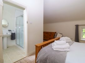 A bedroom with a bed and an attached bathroom at No 2 The Stables Capel Coch near Llannerch-Y-Medd