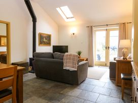 A living room with a couch and television at No 3 The Dairy Capel Coch near Llannerch-Y-Medd