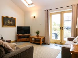 A living room with a television and coffee table at No 3 The Dairy near Llannerch-Y-Medd