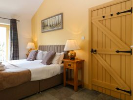 A bedroom with a bed and lamp at No 3 The Dairy in Capel Coch near Llannerch-Y-Medd