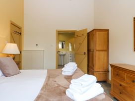 A bedroom with a bed and towels on it at No 3 The Dairy Capel Coch near Llannerch-Y-Medd