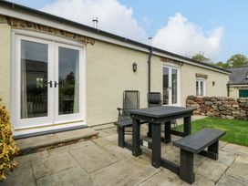 A patio with a table and chairs at No 3 The Dairy Capel Coch near Llannerch-Y-Medd
