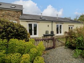 A house with a fence and garden at No 3 The Dairy Capel Coch near Llannerch-Y-Medd