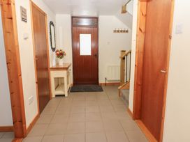 A hallway with a front door and a table at Summerseat in Kirkby Stephen