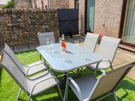 An outdoor seating area with a table and chairs at Summerseat in Kirkby Stephen