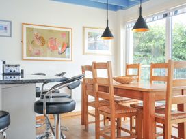 A kitchen with a table and chairs at Beachside in Polzeath